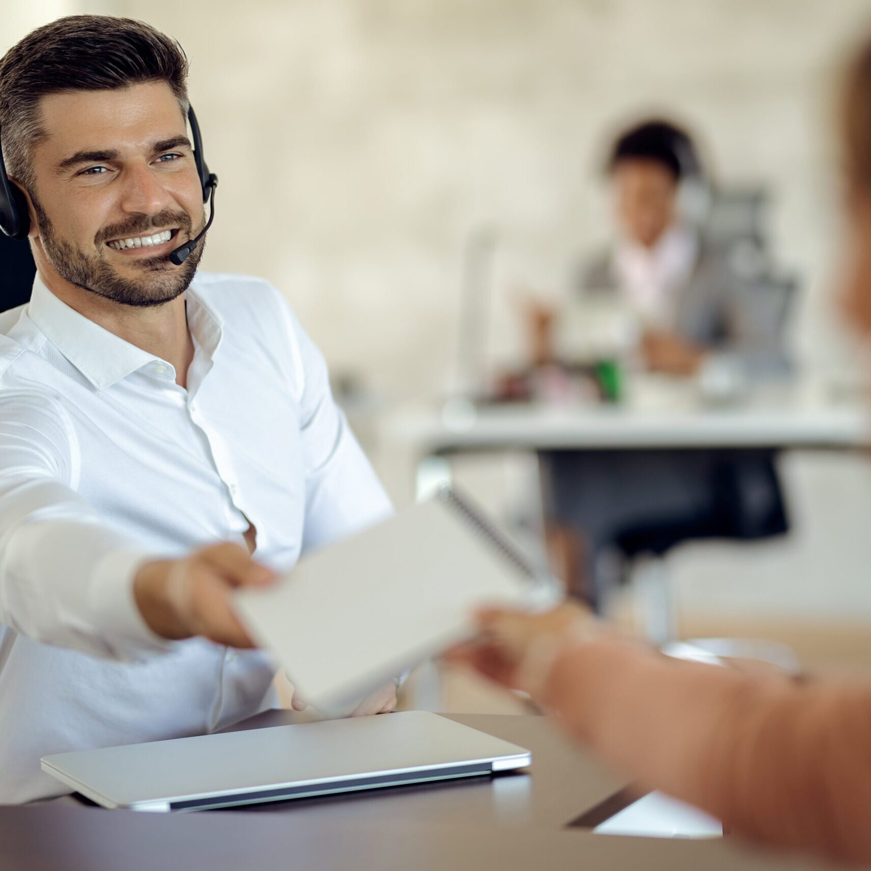 happy-businessman-cooperating-with-his-colleague-while-working-office-min