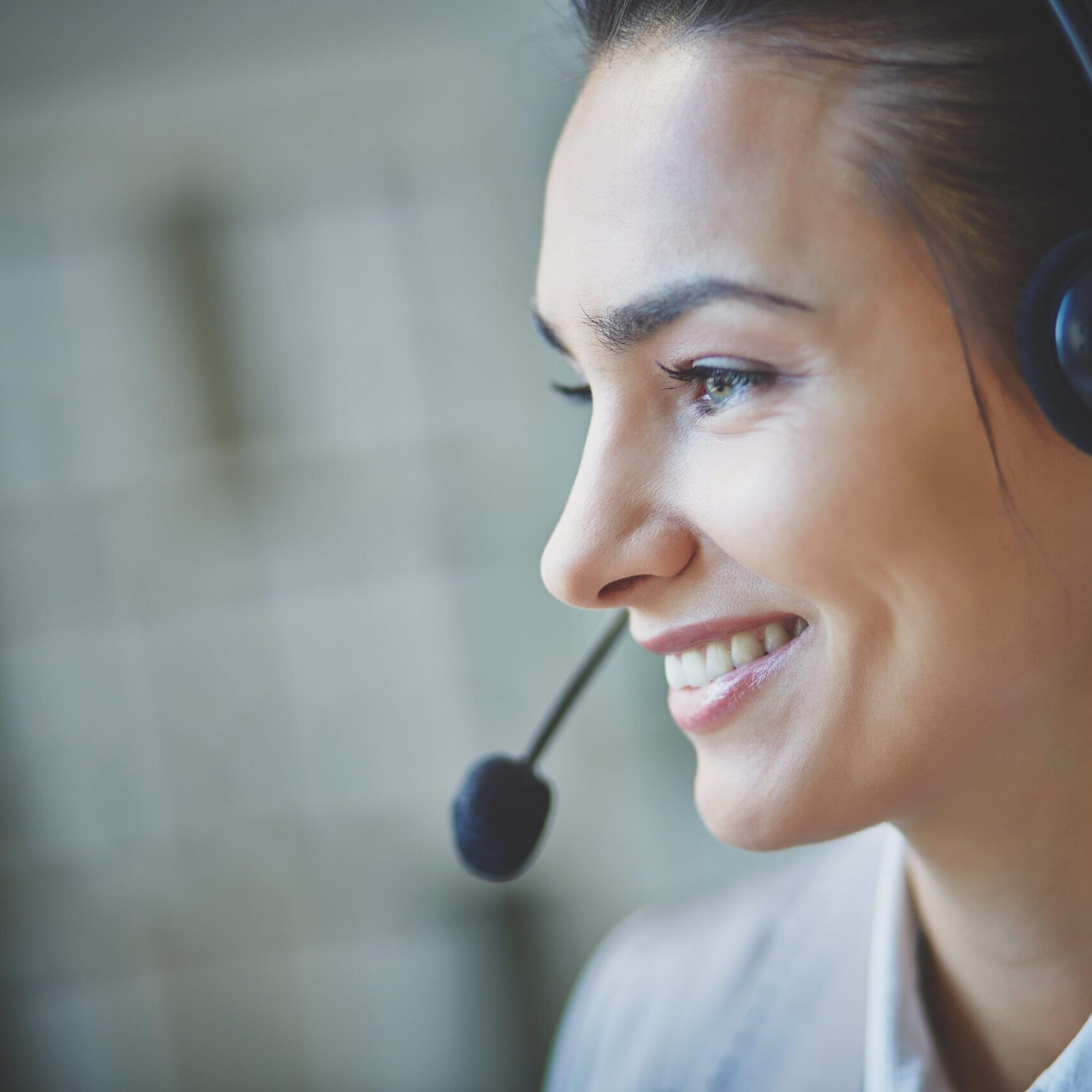 smiling-executive-using-headset-min